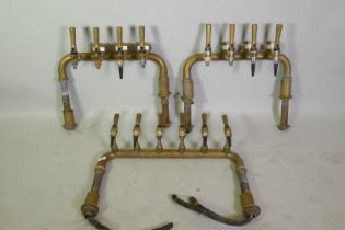 Three brass beer taps, 65 x 50cm