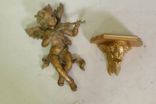 A vintage gilt composition figure of putto playing the violin, 40cm high, and a wall bracket