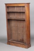 A 1920's oak open bookcase fitted adjustable shelves with fluted columns to the sides, raised on a