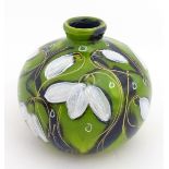 An Anita Harris green glazed vase of squat form decorated with Snowdrops. Signed under. Approx. 3
