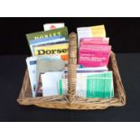 A BASKET CONTAINING MAPS AND GUIDES