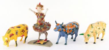 Four Cow Parade hand painted model cows, the largest 20cm high.