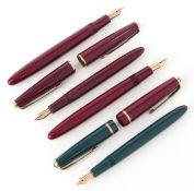 Four Parker fountain pens with 14K gold nibs.