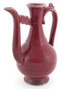 Chinese porcelain red glazed ewer bearing four figure character mark to the base, 20cm high.