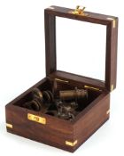 Shipping interest brass sextant housed in a glazed wooden case, 10cm wide.
