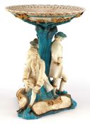 19th century Continental porcelain tazza moulded as figures resting under a tree, 34cm high x 26cm