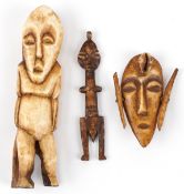 Three African tribal interest figural bone carvings, one in the form of a mask, the largest 14cm