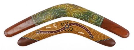 Two Aboriginal interest hand painted wood boomerangs, the largest 64cm wide.