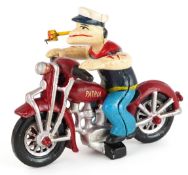 Novelty painted cast iron Popeye figure with articulated limbs, sitting on a motorbike, 21cm in