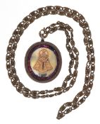 Antique white metal mother of pearl reliquary pendant hand painted with religious icons, on a