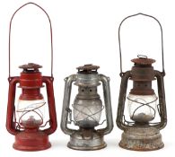 Three vintage tin oil lamps, the largest 23cm high