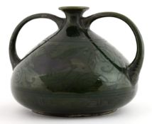 Japanese Meiji period art pottery green glazed squat vase having twin loop handles, with Greek key