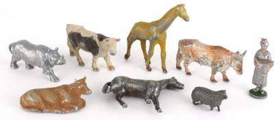 Small collection of metal animal figurines including cows, giraffe, rhinoceros and horses, the