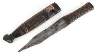 Tribal interest Shona Bakatwa dagger and scabbard with iron blade and carved geometric design,