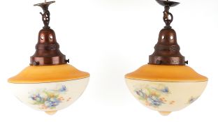 Pair of Art Deco peach glass ceiling lights, decorated with flowers, 26cm in diameter.