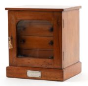 Edwardian mahogany four drawer collector's cabinet with glazed door bearing a silvered metal