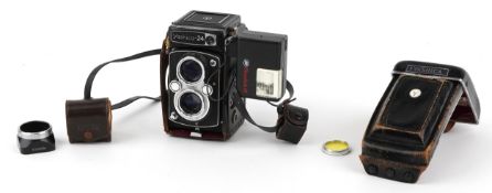 Vintage Yashica 24 camera with leather case and flash unit.