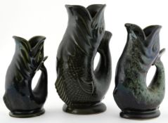 Four ceramic gluggle fish jugs including Dartmouth Devon, Fosters Studio Cornwall, 23cm high.