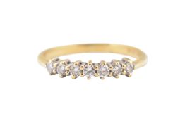 A HALLMARKED 18CT GOLD & DIAMOND SEVEN STONE RING