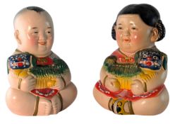 MID CENTURY CHINESE CERAMIC MONEY BOXES IN THE FORM OF A BOY AND A GIRL