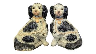 A PAIR OF 19TH CENTURY STAFFORDSHIRE CERAMIC FIRESIDE MANTLE DOGS