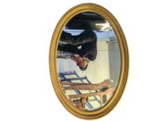 20TH CENTURY OVAL GILT FRAMED WALL MIRROR
