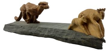 EARLY 2000S CARVED OAK AND ELM SCULPTURE DEPICTING A CHEETAH HUNTING ITS PREY