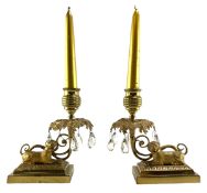 PAIR OF FRENCH 19TH CENTURY BRASS CANDLESTICKS WITH SEATED DOGS