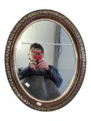 EARLY 20TH CENTURY CARVED WALNUT OVAL WALL HANGING MIRROR