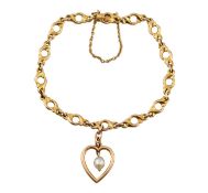 EARLY 20TH CENTURY 15CT GOLD FANCY LINK BRACELET WITH HEART CHARM