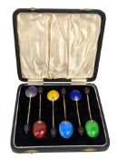 CASED SET OF SIX GEORGE V SILVER GILT AND ENAMEL COFFEE BEAN TEASPOONS