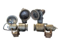 FIVE EARLY TO MID 20TH CENTURY CARBIDE BICYCLE / MOTORCYCLE LAMPS