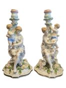 A PAIR OF 19TH CENTURY MANNER OF MEISSEN CONTINENTAL PORCELAIN FIGURAL CANDLESTICKS