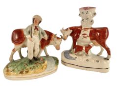 A PAIR OF 19TH CENTURY STAFFORDSHIRE HAND PAINTED CERAMIC FIGURES