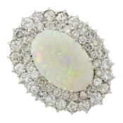 An opal ring, with diamond undulating surrounds