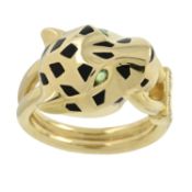 An enamel 'Panthère de Cartier' ring, with onyx nose, garnet eyes and diamond grip, by Cartier