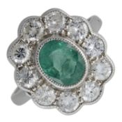 An emerald & diamond cluster ring