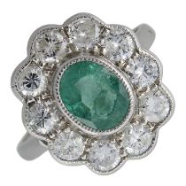 An emerald & diamond cluster ring