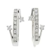 A pair of diamond hoop earrings