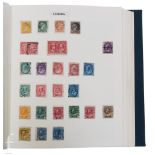 A collection of Commonwealth and world postage stamps contained within four Stanley Gibbons Plymouth
