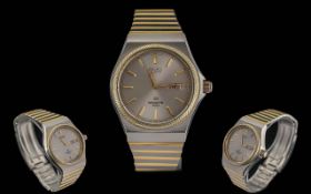 Seiko Sports 100 Gents Stainless Steel and Gold Tone Quartz Day-Date Display Wrist Watch.
