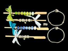Collection of Charms, and two bracelets.