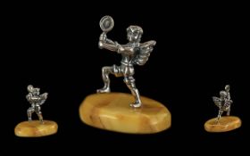 Novelty Silver Figure on an Amber Base. Winged Figure In Silver on An Amber Base.
