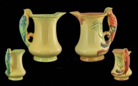 Two Burleigh Ware Parrot Handled Jugs, yellow base with brightly coloured parrot figure handles. 8.