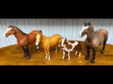 Four Beswick Horses, two brown matte, palomino, and a piebald.