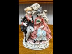Capodimonte Figurine featuring a romantic couple in 18th Century attire, seated on a decorative