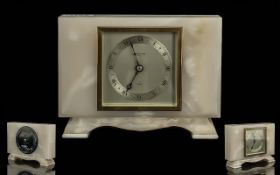 An Elliott White Onyx Mantle Clock, with silvered chapter dial and Roman numerals. Marked