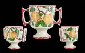 Wemyss - Early T.Goode & Co Twin Handle Cup. Oranges / Leaf's Design on White Ground. Height 6.5