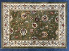 Rug by Empress at Jane Plumb Home, wool with pattern in green, pink and cream, with central design