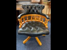 Captain's Chair, black leather seat and button back, swivel, on casters, with a beech wood frame.